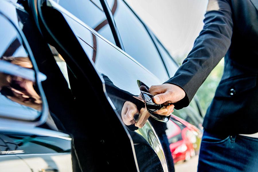 Dedicated private driver — chauffeur opening car door